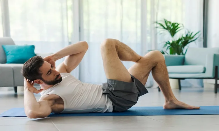 Exercises to Stop Premature Ejaculation Naturally Exercises to stop premature ejaculation naturally. Fit man performing bicycle crunches on a blue yoga mat in a bright living room.